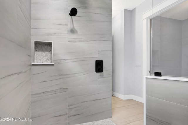 bathroom with tiled shower