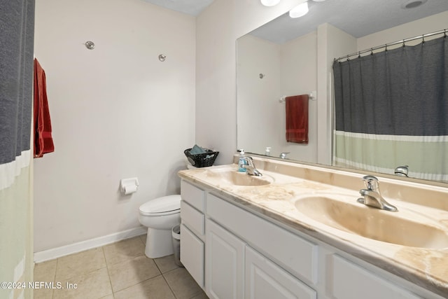 bathroom with tile patterned floors, vanity, toilet, and a textured ceiling