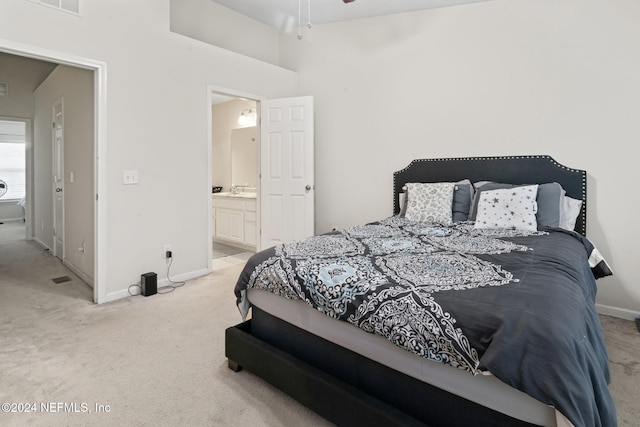 carpeted bedroom featuring connected bathroom