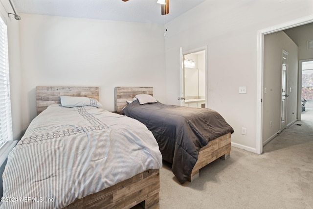 carpeted bedroom featuring ceiling fan and ensuite bathroom