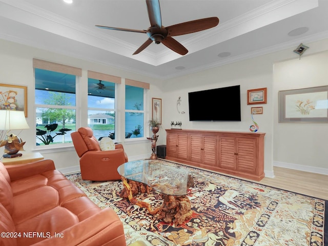 living room with hardwood / wood-style flooring, ceiling fan, and ornamental molding