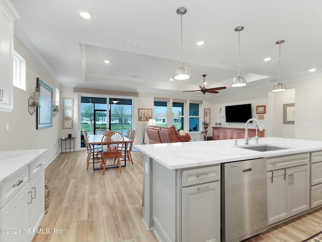 kitchen featuring ceiling fan, dishwasher, sink, a raised ceiling, and light hardwood / wood-style floors