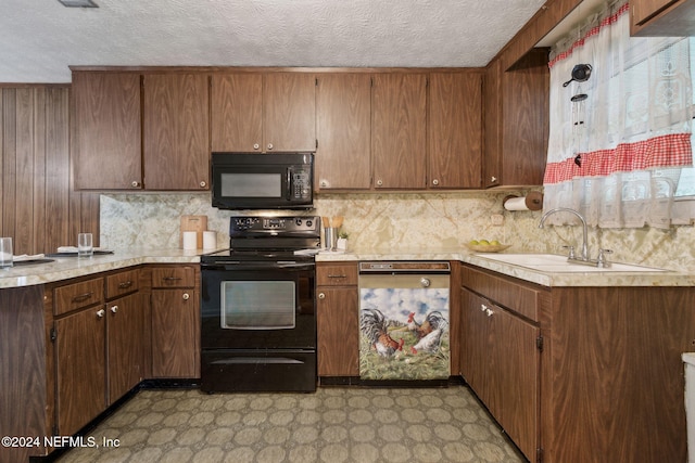 kitchen with sink, black appliances, and a textured ceiling