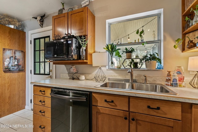 kitchen featuring sink, light tile patterned floors, and stainless steel dishwasher