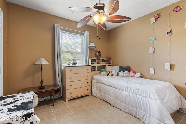 bedroom with light tile patterned floors and ceiling fan