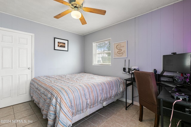 tiled bedroom with ceiling fan and wooden walls