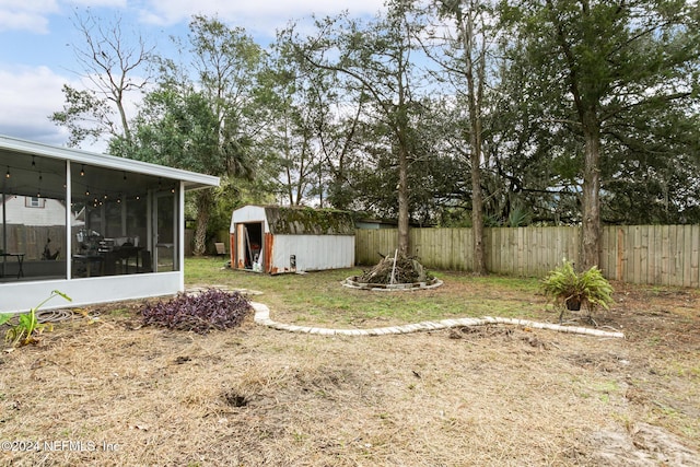 view of yard with a sunroom and a shed