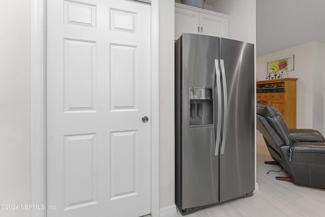 kitchen with white cabinetry and stainless steel refrigerator with ice dispenser