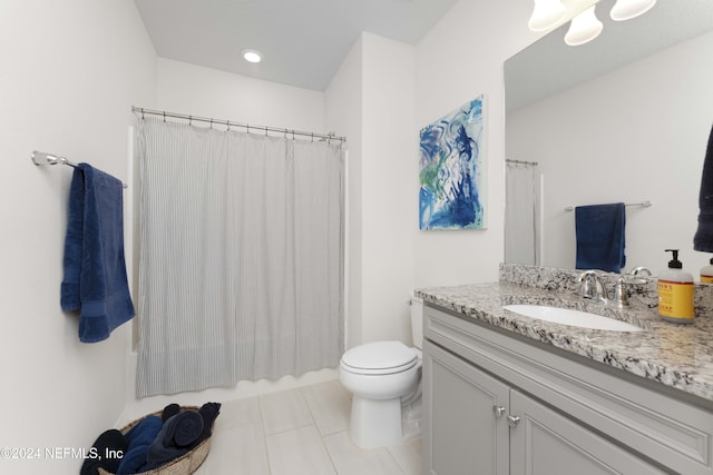 bathroom with walk in shower, tile patterned flooring, vanity, and toilet