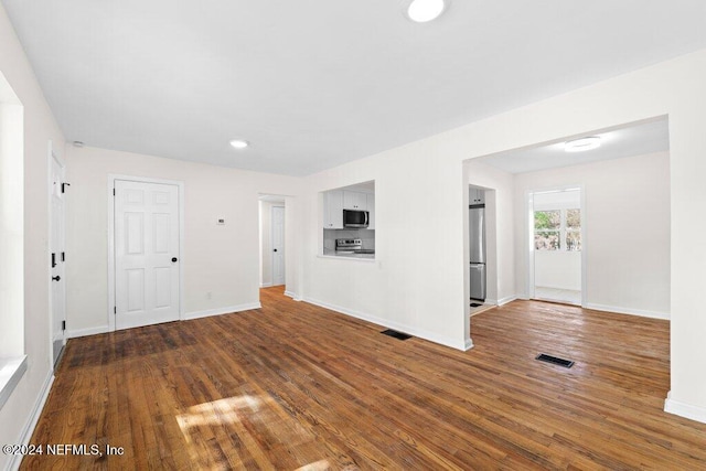 unfurnished living room featuring wood-type flooring