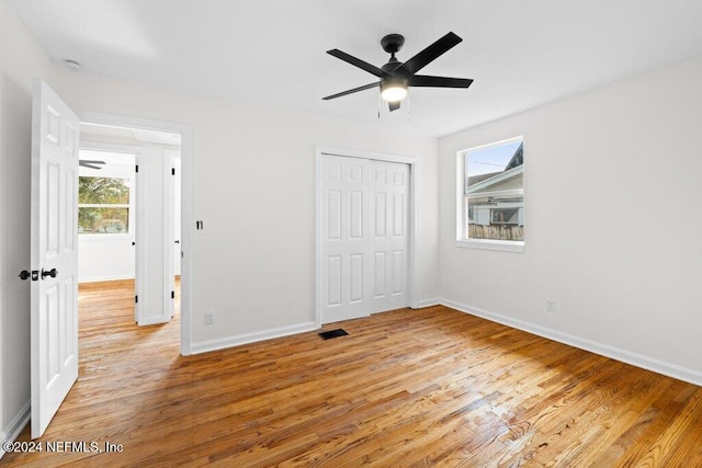 unfurnished bedroom with ceiling fan, a closet, and light hardwood / wood-style floors