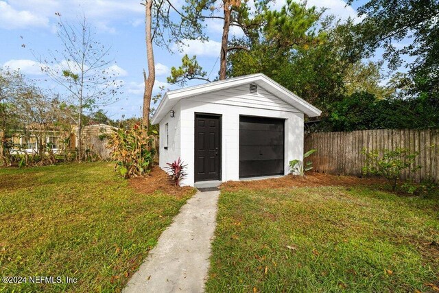 view of outbuilding featuring a lawn