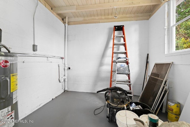 interior space featuring water heater, beamed ceiling, concrete floors, and wooden ceiling