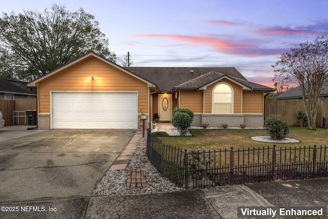 ranch-style home with a garage and a lawn