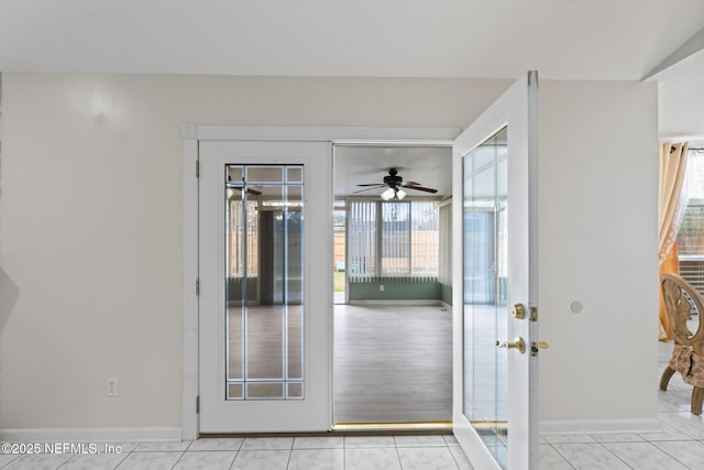 entryway featuring vaulted ceiling, ceiling fan, and light tile patterned floors