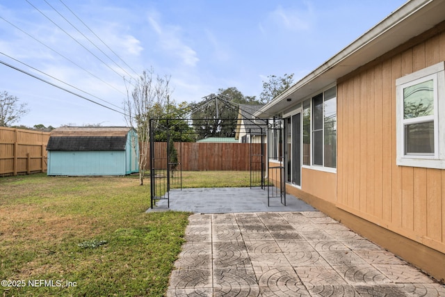 view of yard with a gazebo, a storage shed, and a patio area