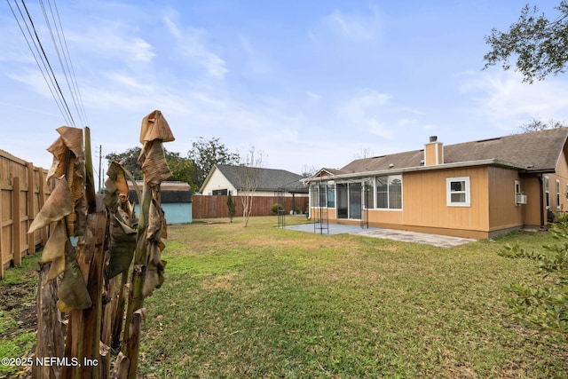 view of yard featuring a patio and a storage unit