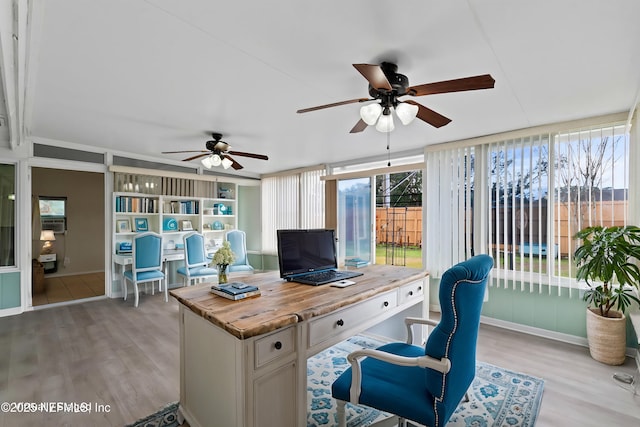 office area featuring ceiling fan, light wood-type flooring, and plenty of natural light