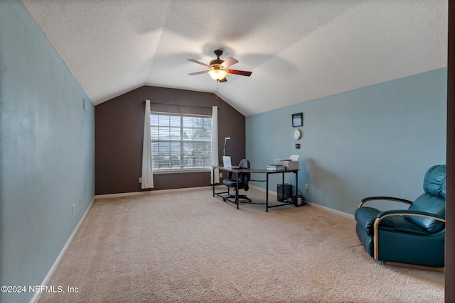 carpeted home office featuring ceiling fan, a textured ceiling, and vaulted ceiling