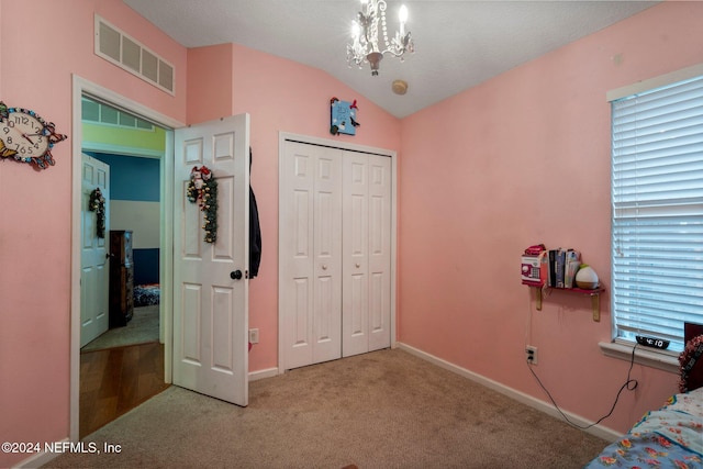 bedroom featuring light carpet, multiple windows, vaulted ceiling, and a closet