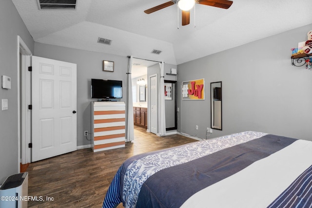 bedroom featuring ceiling fan, dark hardwood / wood-style flooring, lofted ceiling, and connected bathroom