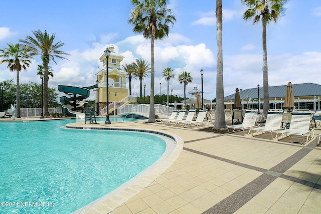 view of pool featuring a patio and a water slide