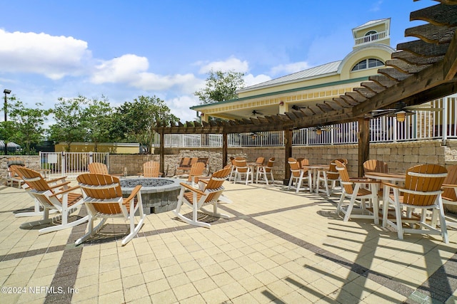 view of patio featuring a pergola, ceiling fan, and a fire pit