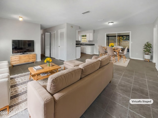 living room featuring dark tile patterned flooring