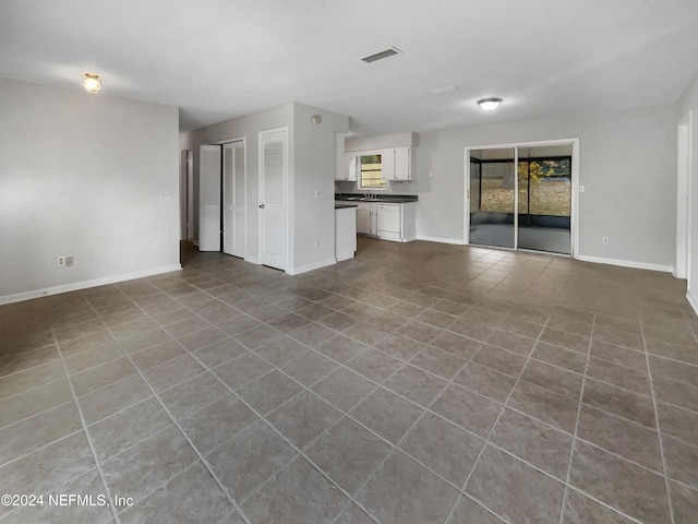 unfurnished living room featuring tile patterned floors