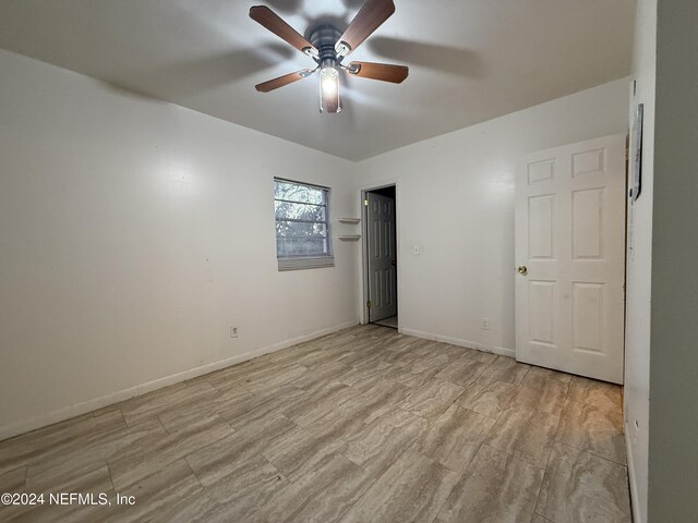 spare room with light hardwood / wood-style floors and ceiling fan