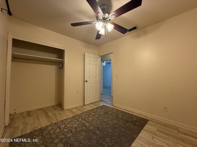 unfurnished bedroom with a closet, ceiling fan, and light hardwood / wood-style flooring