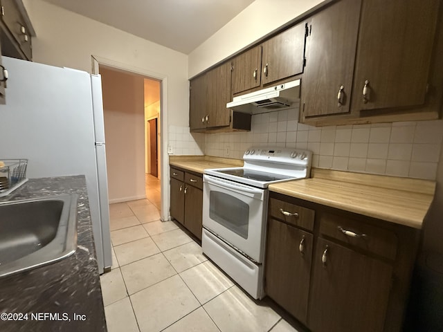 kitchen featuring white appliances, sink, light tile patterned floors, tasteful backsplash, and dark brown cabinets