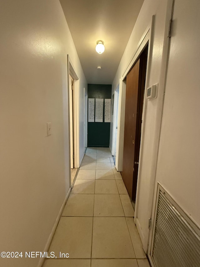 hall with light tile patterned floors