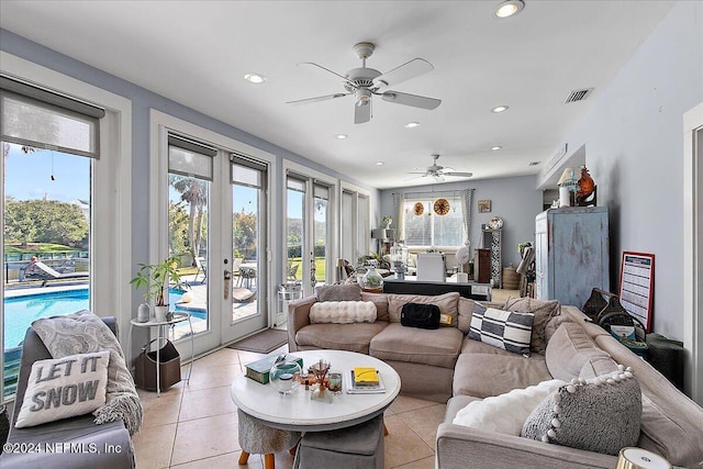 tiled living room with french doors and ceiling fan