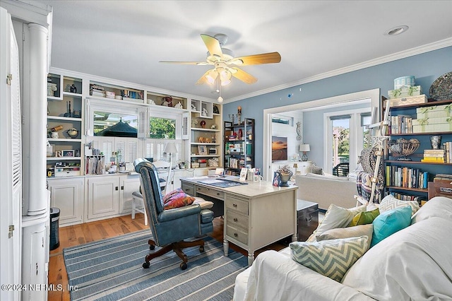 office with hardwood / wood-style flooring, a healthy amount of sunlight, and ornamental molding