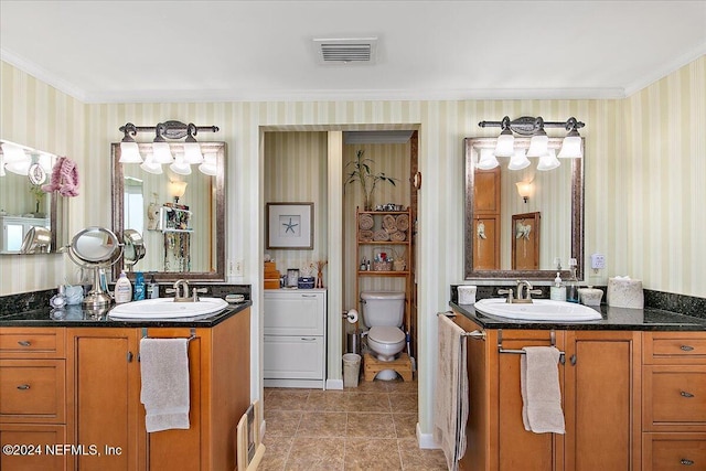 bathroom with vanity, toilet, and crown molding