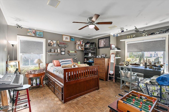 bedroom with ceiling fan, ornamental molding, and light parquet flooring