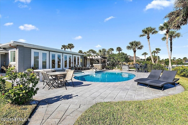 view of pool featuring french doors and a patio