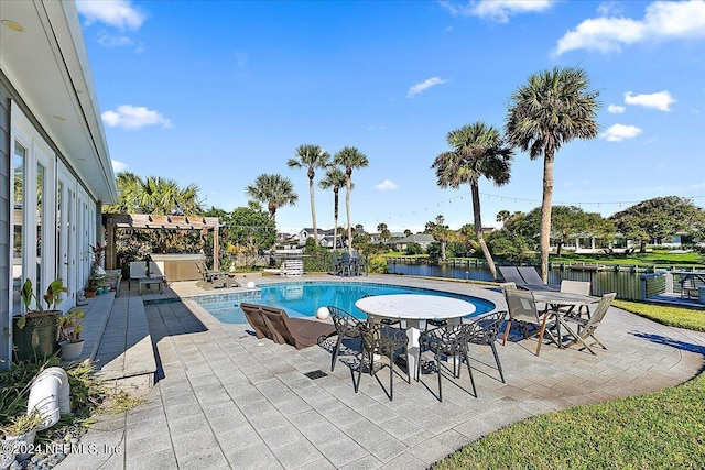 view of pool with a pergola, a patio area, and a water view