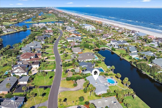 birds eye view of property featuring a water view and a view of the beach