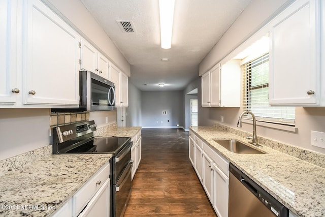 kitchen featuring light stone countertops, stainless steel appliances, sink, white cabinets, and dark hardwood / wood-style floors