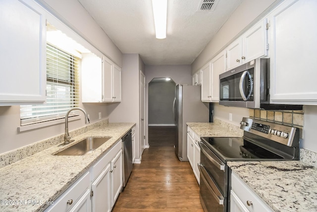 kitchen featuring appliances with stainless steel finishes, white cabinetry, and sink