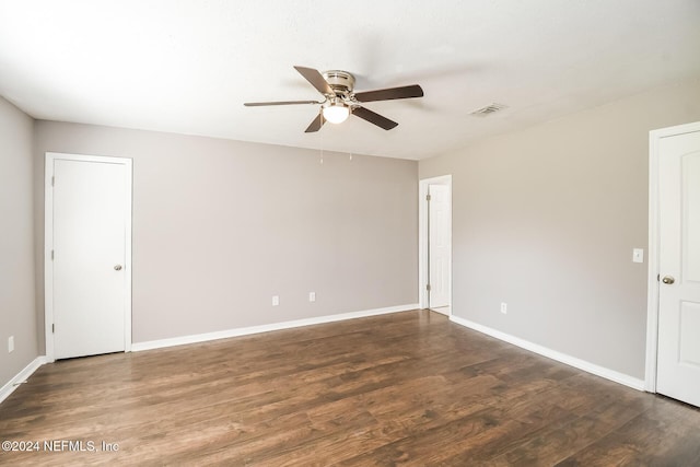 empty room featuring ceiling fan and dark wood-type flooring