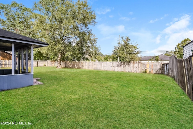 view of yard featuring a sunroom