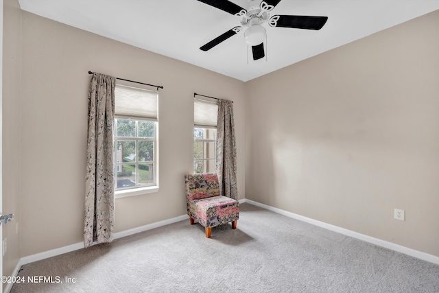 living area featuring carpet floors and ceiling fan