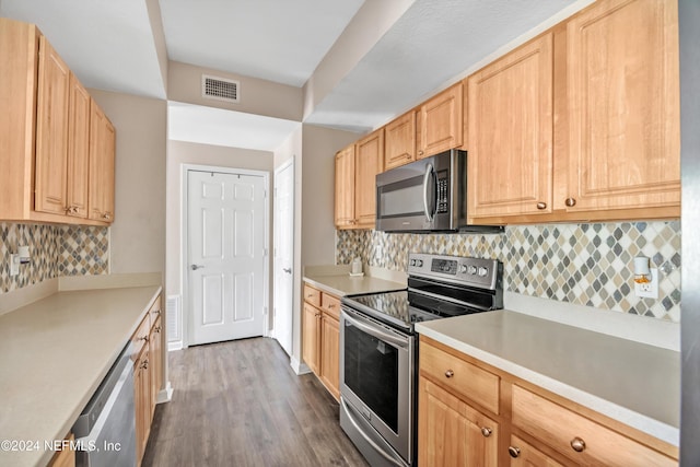 kitchen with decorative backsplash, appliances with stainless steel finishes, dark hardwood / wood-style floors, and light brown cabinetry