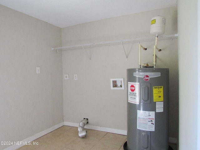 laundry area with washer hookup, tile patterned floors, and water heater