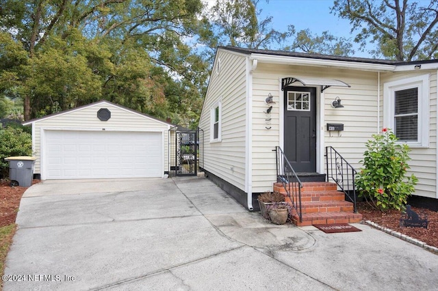 view of front facade featuring a garage and an outbuilding