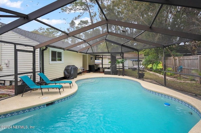 view of pool featuring area for grilling, a lanai, and a patio area