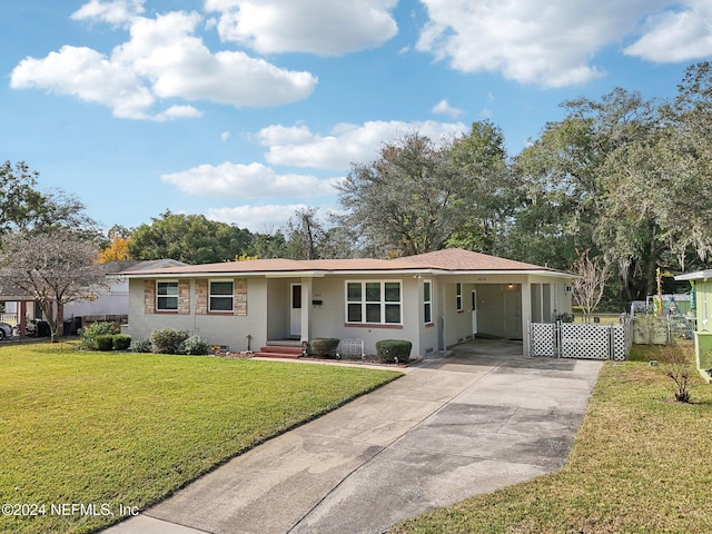 ranch-style home featuring a carport and a front yard